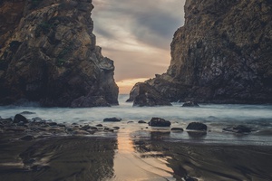Twilight Reflections on a Rocky Beach