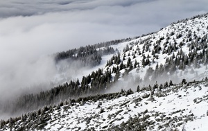 Mystical Fog Over Snowy Peaks